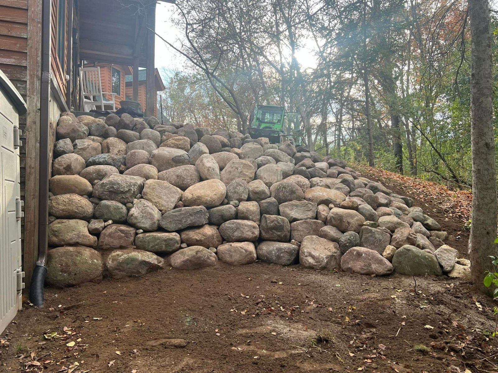 Natural boulder retaining wall on a hillside