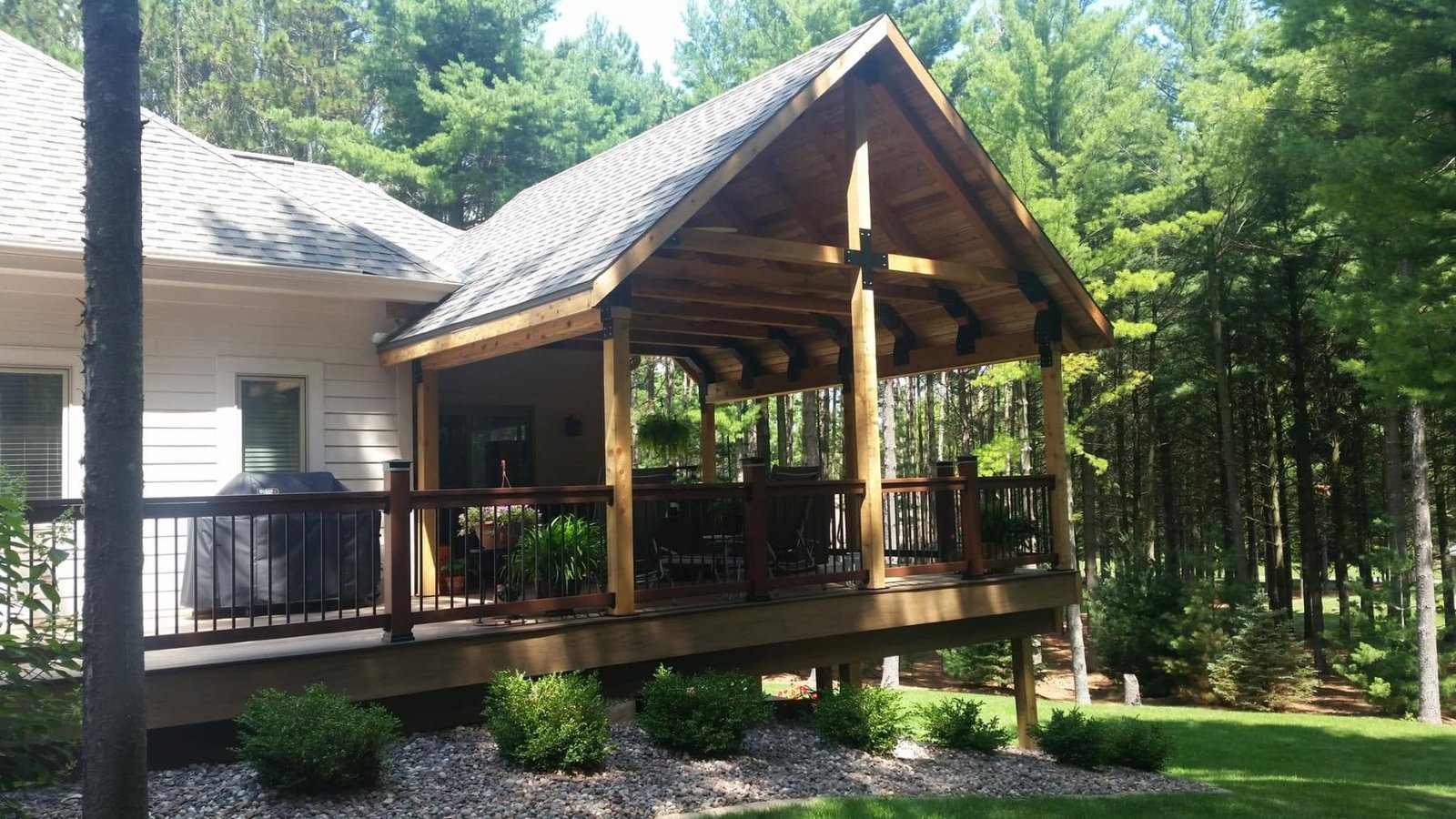 Covered timber-frame porch with wood ceiling