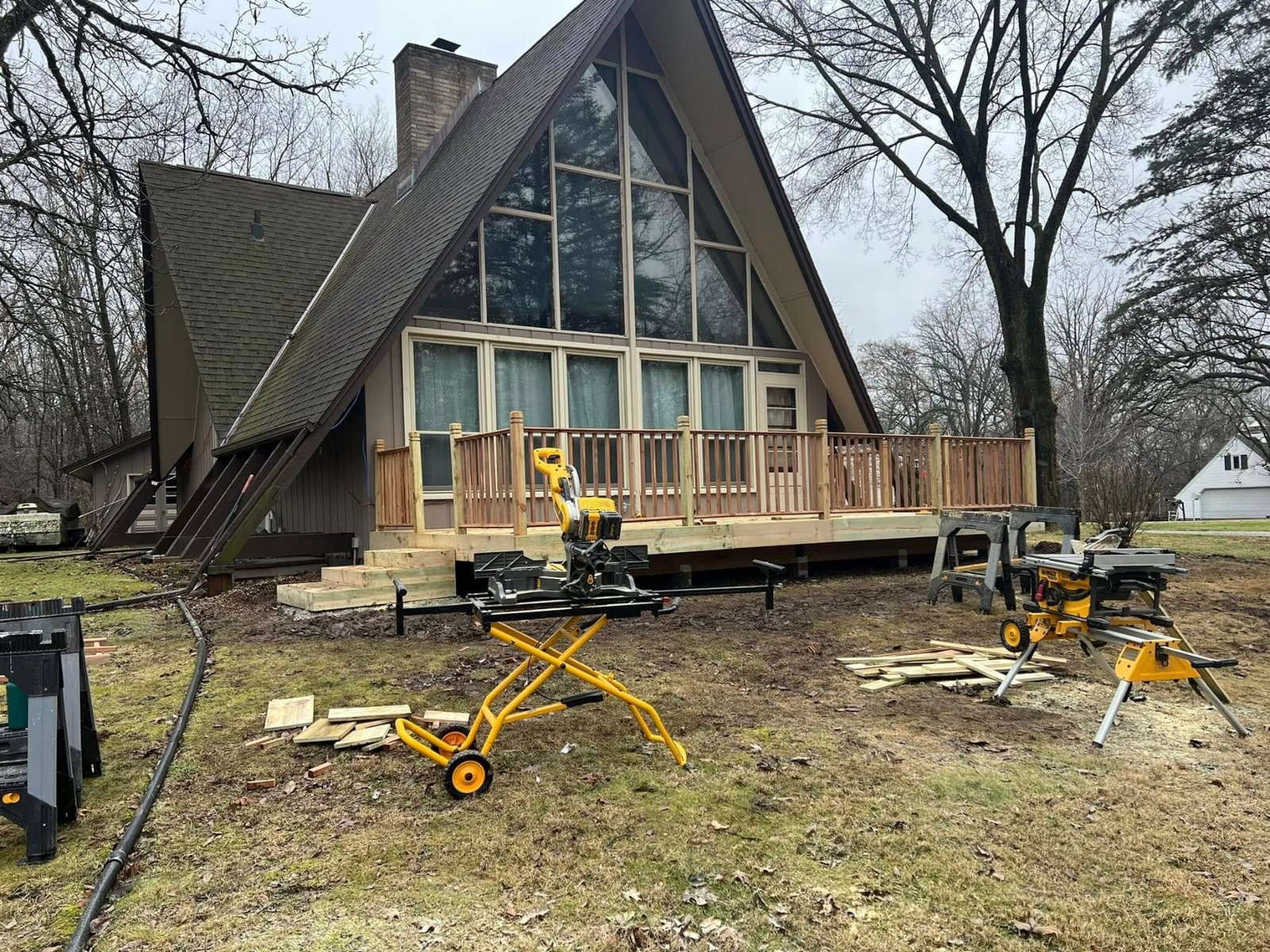 New deck across the front of an A-frame house
